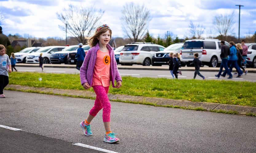 Students run around the track